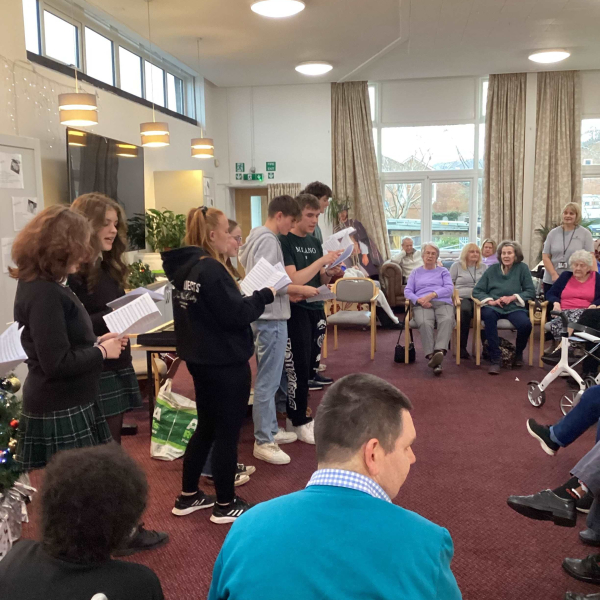 Secondary School pupils singing carols